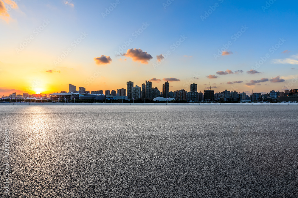Fototapeta premium Asphalt road ground and city skyline at sunset in Shanghai,China.
