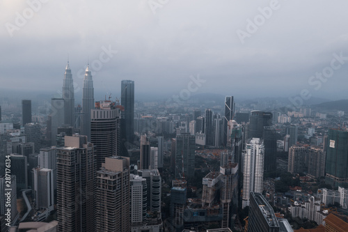 Aerial drone view of Kuala Lumpur city skyline during cloudy day © stryjek