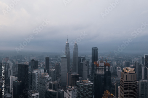 Aerial drone view of Kuala Lumpur city skyline during cloudy day