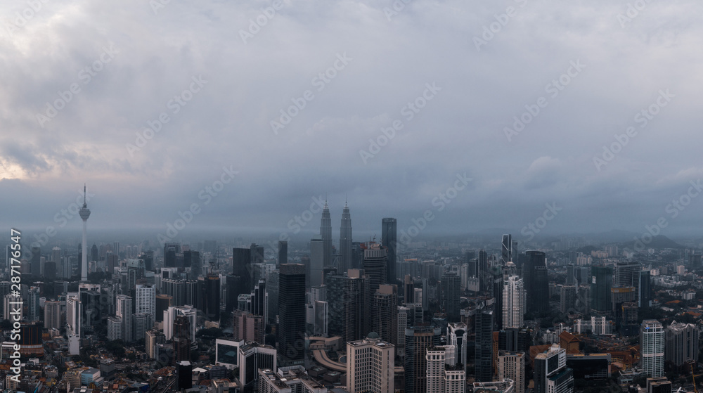 Aerial panorama of Kuala Lumpur city skyline during cloudy day