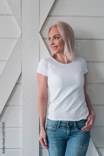 Portrait of a beautiful smiling blonde. Ready-made white t-shirt layout for design.