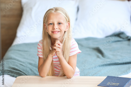 Little girl praying at home