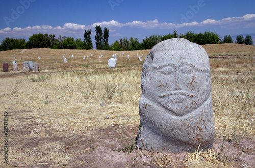 Ancient stone sculptures (Kurgan stelae or Balbals) near the Burana Tower in Kyrgyzstan photo