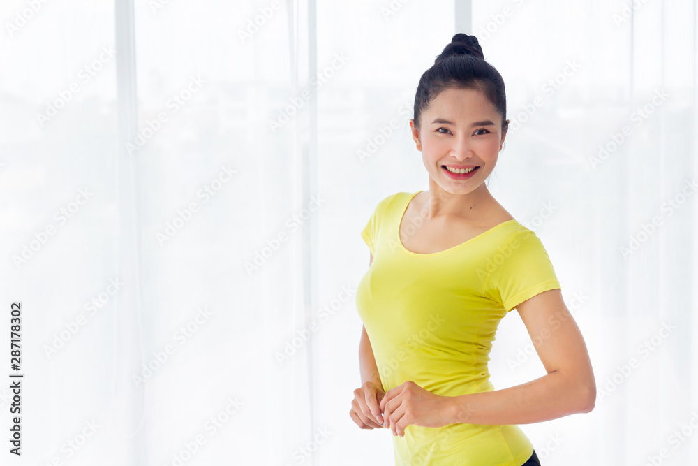 Portrait of Beautiful Asian woman is prepared to exercise yoga in the yoga room for good health and flexibility of the muscles with feel good and happiness. It is a lifestyle activity healthy