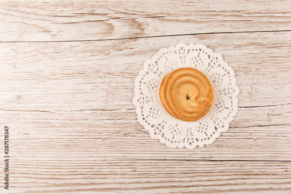 Danish Butter Biscuit in beautiful white lace and wooden background. Danish Cookies. top view. copy space Danish Butter Biscuit in beautiful white lace and wooden background. Danish Cookies. top view. copy space
