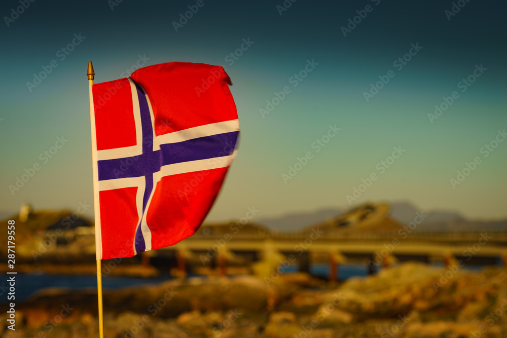 Naklejka premium Norwegian flag against Atlantic Road, Norway