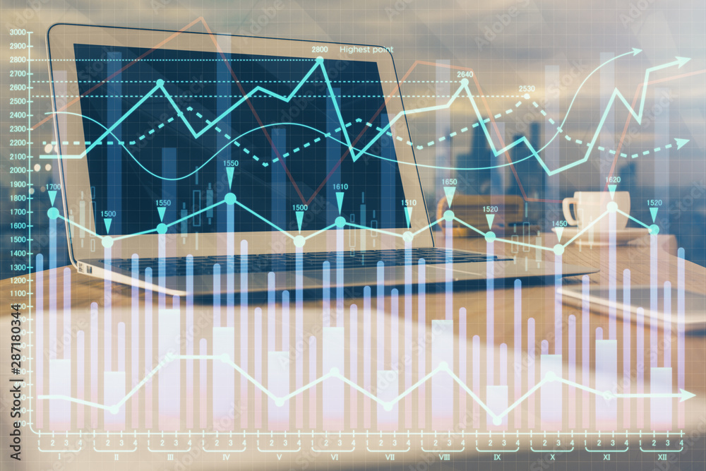 Financial chart drawing and table with computer on background. Double exposure. Concept of international markets. Financial chart drawing and table with computer on background. Double exposure. Concept of international markets.