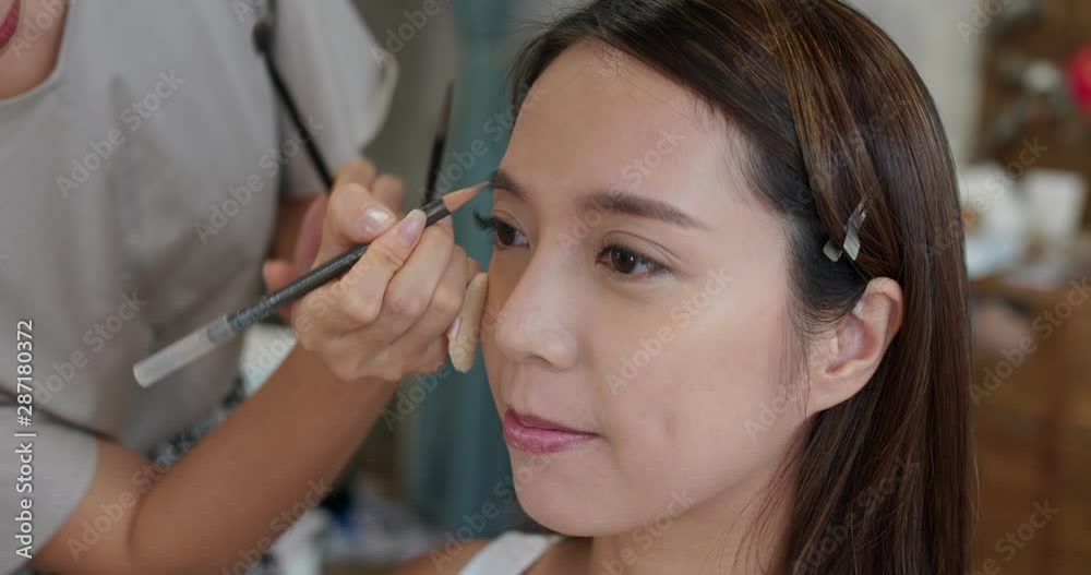 Woman having make up by artist in the studio Woman having make up by artist in the studio