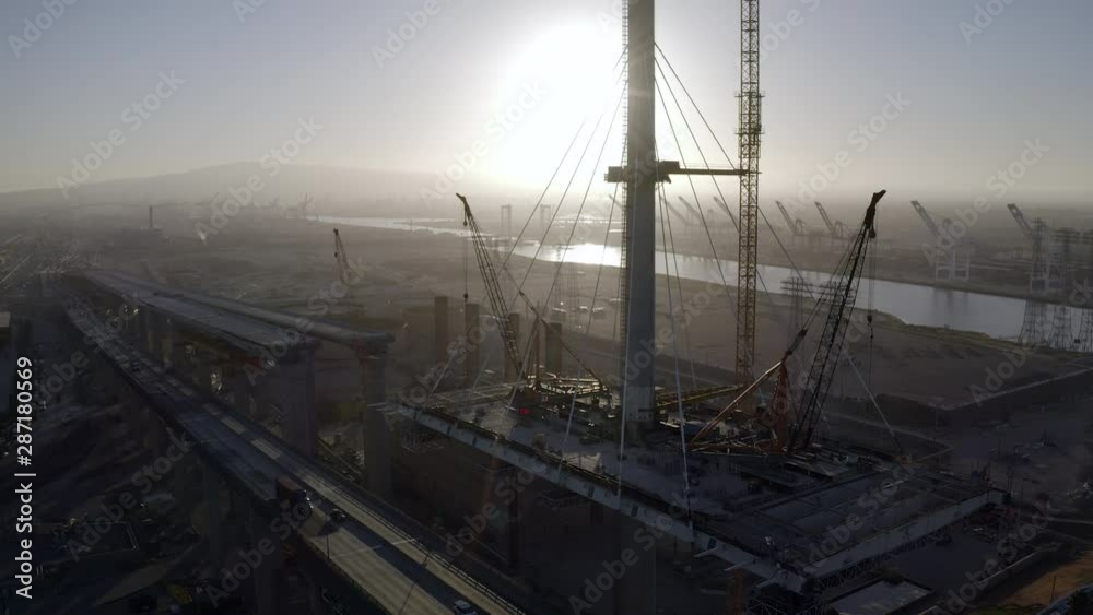 Aerial Tilt: Bridge Under Construction Next to Old Steel Bridge in Port of Lost Angeles at Sunset - San Pedro, California
