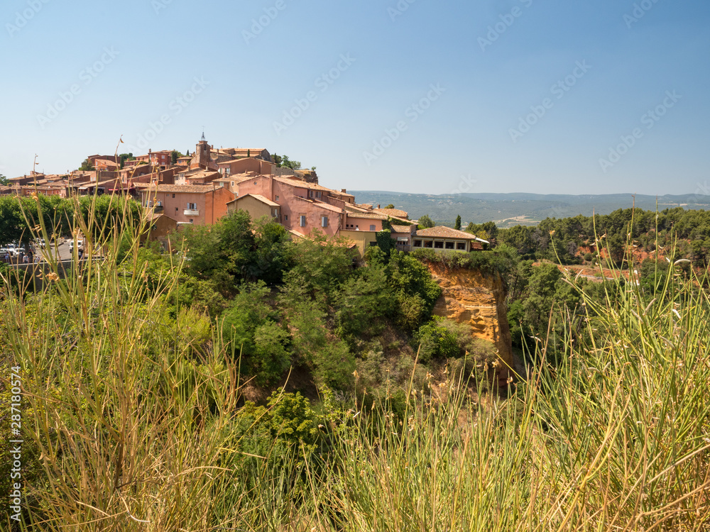 France, july 2019: Old Town of Roussillon, Provence, known as one of the most beautiful villages of France (Les Plus Beaux Villages de France), is situated by the ochre Red Cliffs (Les Ocres)