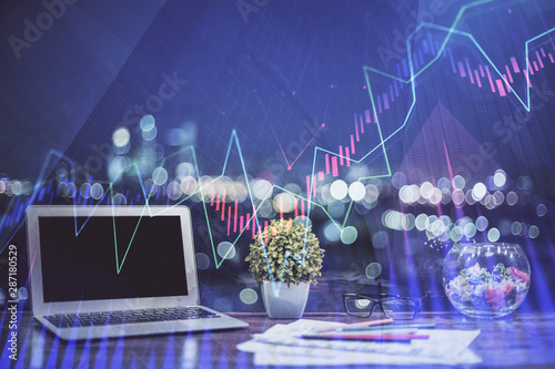 Financial chart drawing and table with computer on background. Double exposure. Concept of international markets. © peshkova