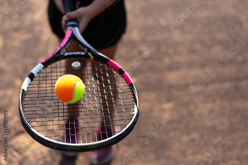 Close-up of tennis ball on racket in hands of player © Lalandrew