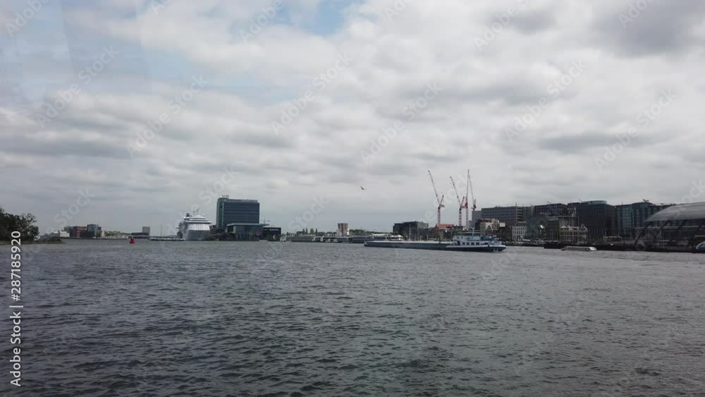 Amsterdam, Netherlands, Holland - May 2019: City transport. A ferry transfers people to the other side of the city. People on the ferry. Amsterdam, Netherlands, Holland - May 2019: City transport. A ferry transfers people to the other side of the city. People on the ferry.