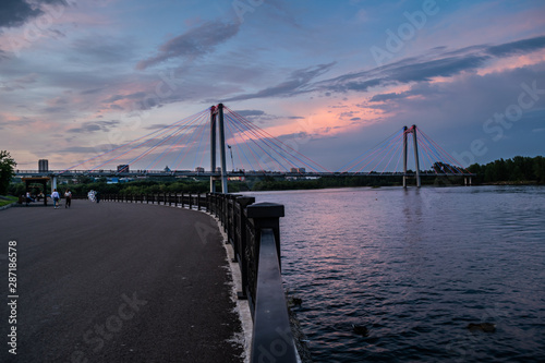 Vinogradovsky bridge over Yenisei river during sunset in Krasnoyarsk, Russia photo