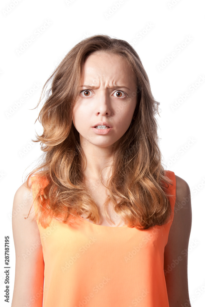 The girl is angry and frowned on a white background. The girl is angry and frowned on a white background.