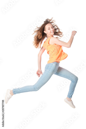 Running smiling girl on a white background in the studio.