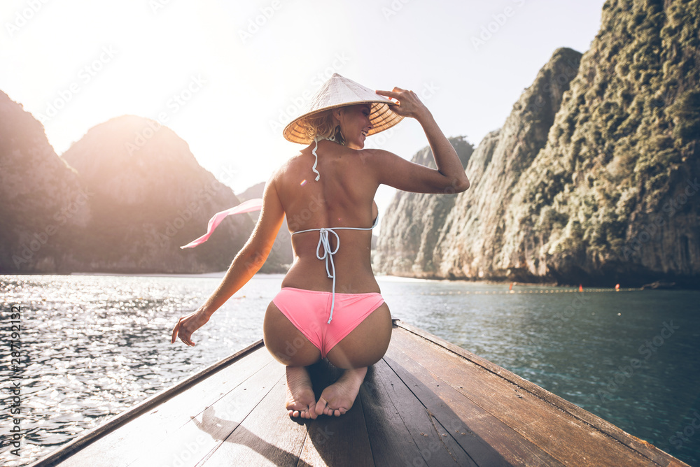 Young woman making a tour on the long tail boat, going to phi phi island - obrazy, fototapety, plakaty 