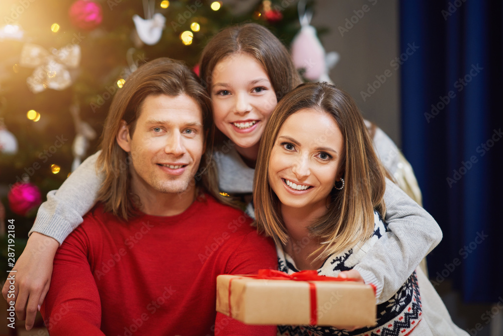 Beautiful family with presents over Christmas tree Beautiful family with presents over Christmas tree