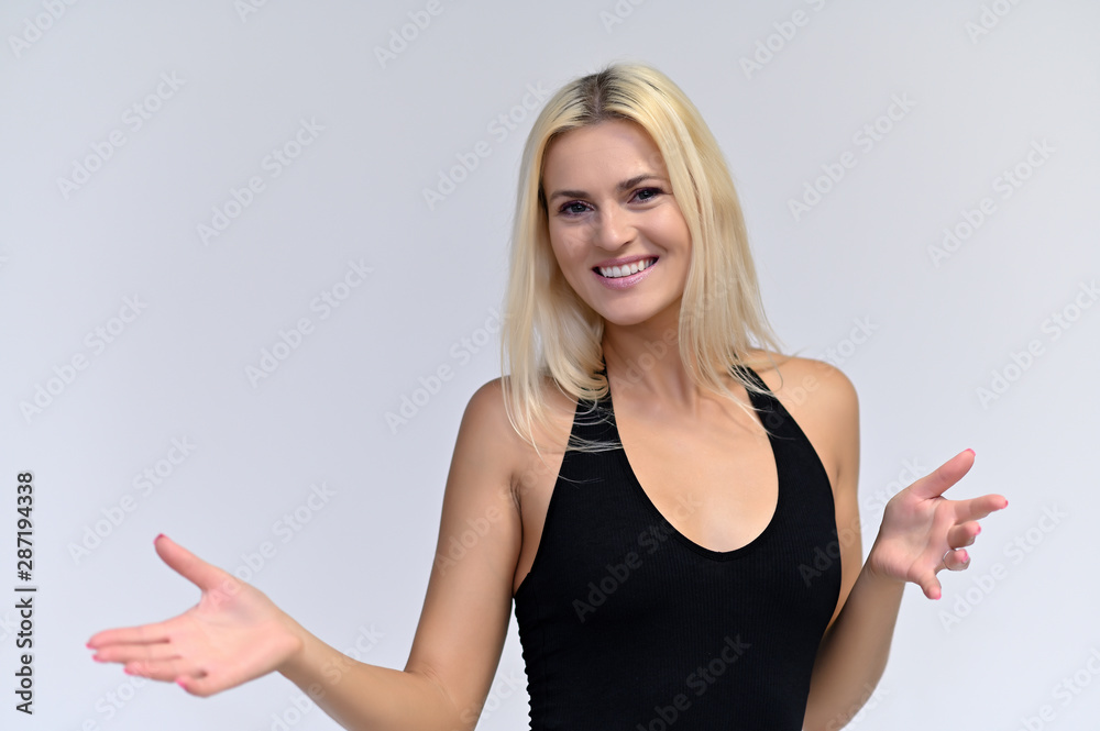 Portrait of a cute girl, a young blonde woman with beautiful curly hair in a black T-shirt on a white background. Beauty, brightness, smile, emotions. Portrait of a cute girl, a young blonde woman with beautiful curly hair in a black T-shirt on a white background. Beauty, brightness, smile, emotions.
