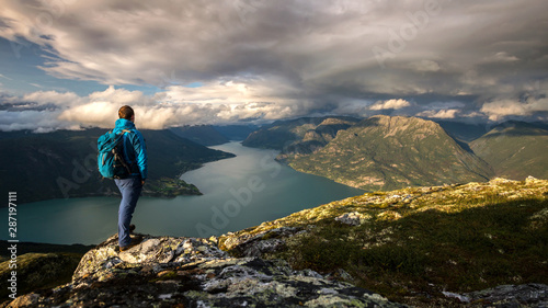 Hiker on top of mountain Molden enjoying the view of Lustrafjord, Norway photo