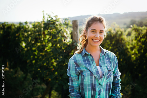 Woman winemaker with grapes in a vineyard photo