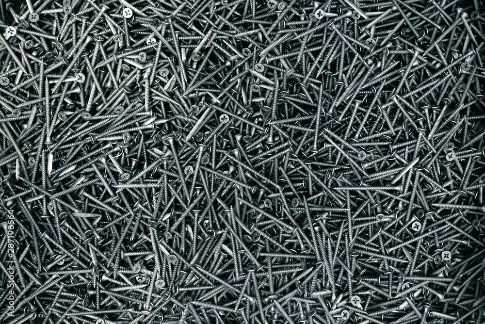 A lot of screws flat lay abstract background. A lot of screws flat lay abstract background.