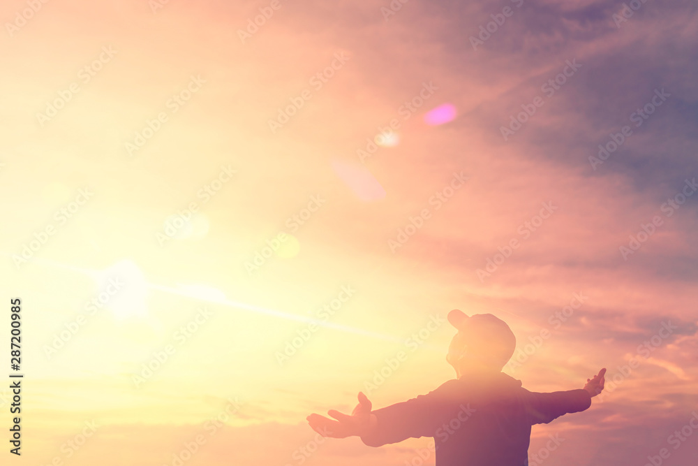 Copy space of silhouette man rising hands up on sunset sky and clouds abstract background. Copy space of silhouette man rising hands up on sunset sky and clouds abstract background.