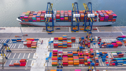 Container ship loading and unloading in deep sea port, Business logistic import and  export freight  shipping transportation by container ship in open sea. photo