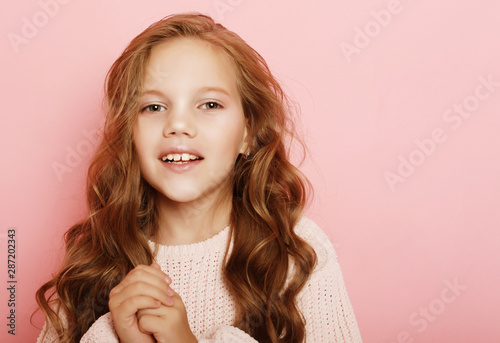 lifestyle and people concept: litle girl kid with long curly hair photo