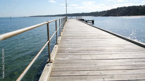 Wallpaper Mural POV camera walk-through long wooden pier on bright sunny day Torontodigital.ca