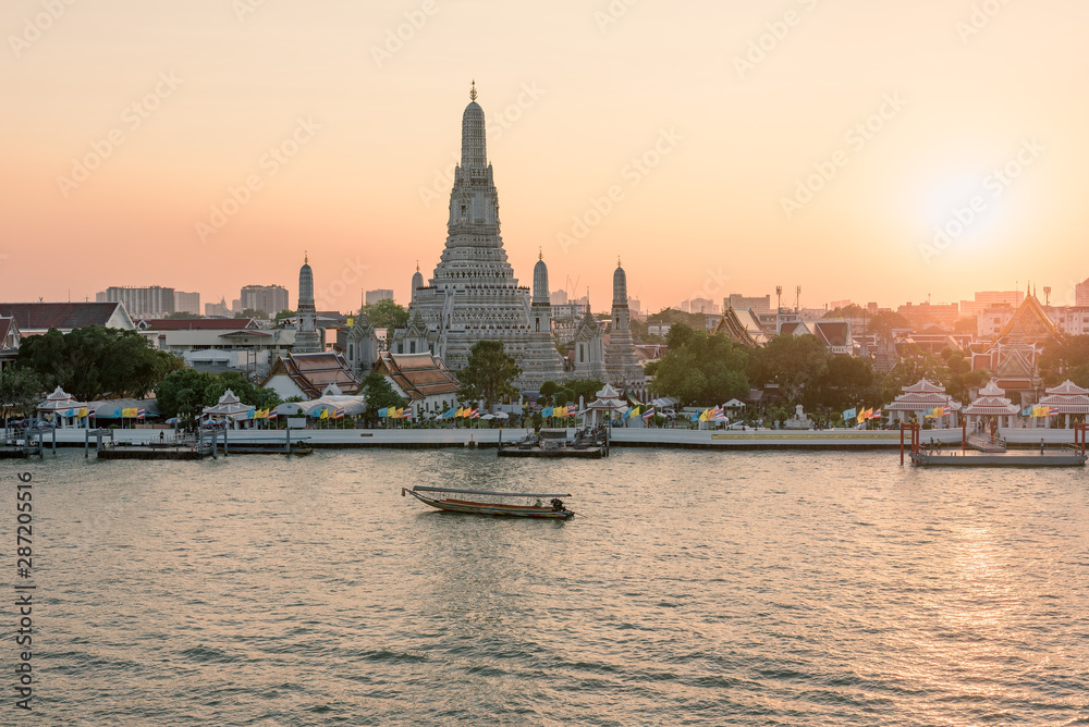 Wat Arun temple along Chao Phraya River during sunset in Bangkok, Thailand