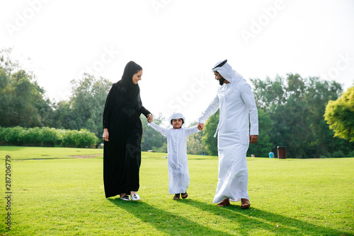 Fototapeta Arabian family spending time in a park