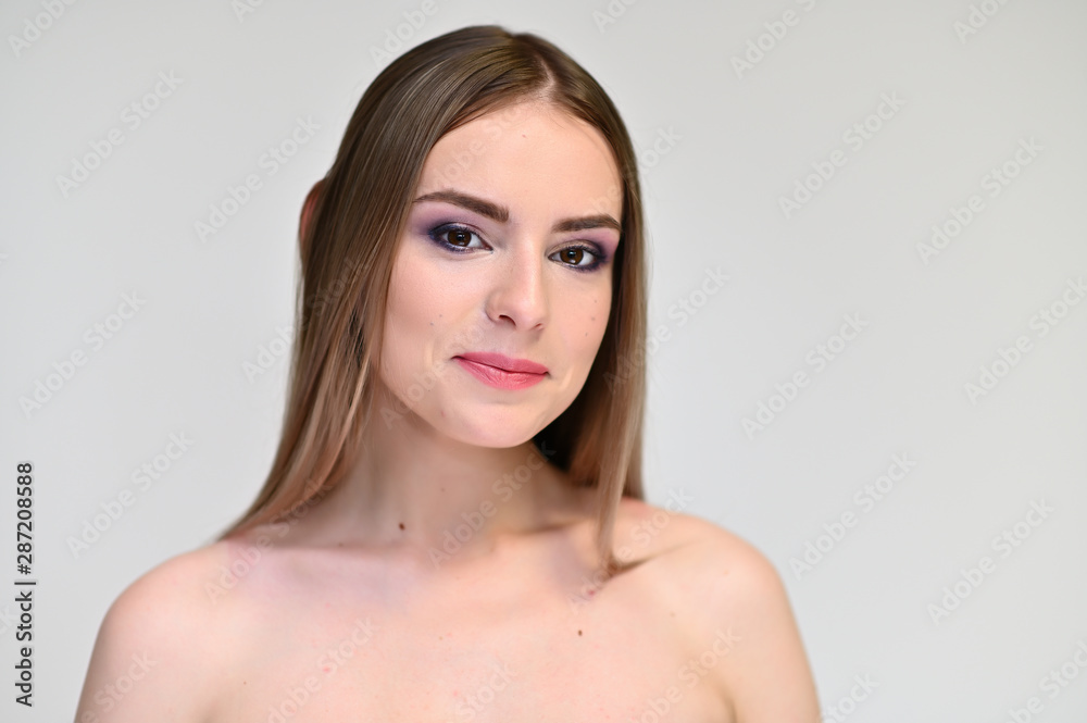 A close-up portrait of a cute girl, a young woman with beautiful curly hair on a white background with excellent face skin and outstanding fashionable make-up. Beauty, brightness. A close-up portrait of a cute girl, a young woman with beautiful curly hair on a white background with excellent face skin and outstanding fashionable make-up. Beauty, brightness.