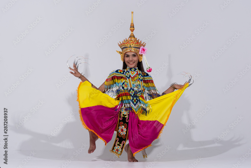 Asian woman in traditional costume of Southern Thailand. Nora dance show.sit,jump in manora style.