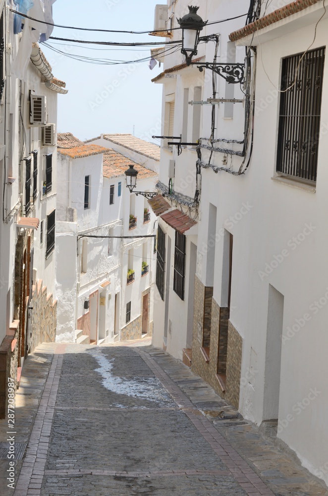 White alley downhill in Casares, Andalusia, Spain