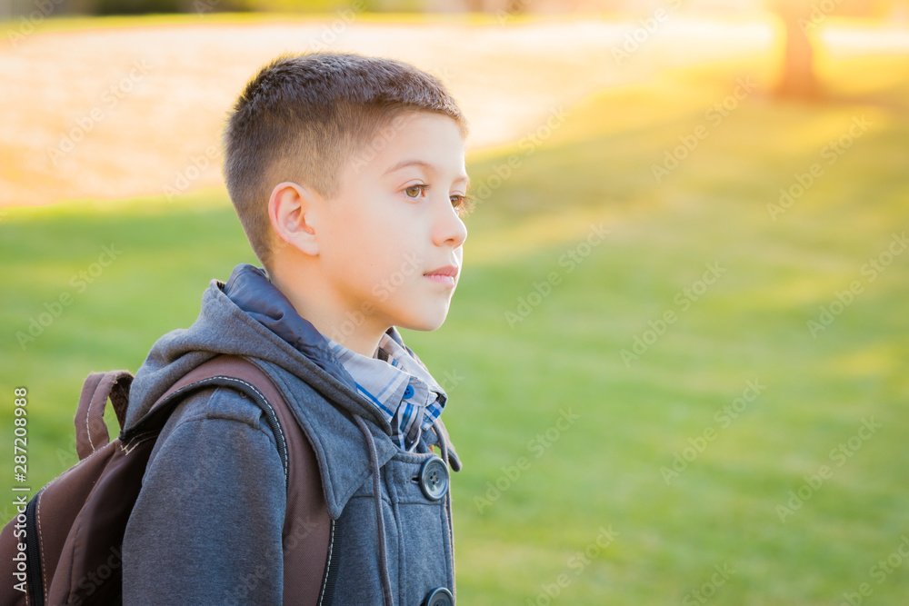 Young Hispanic Boy Walking Outdoors With Backpack Young Hispanic Boy Walking Outdoors With Backpack