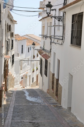 White alley downhill in Casares  Andalusia  Spain