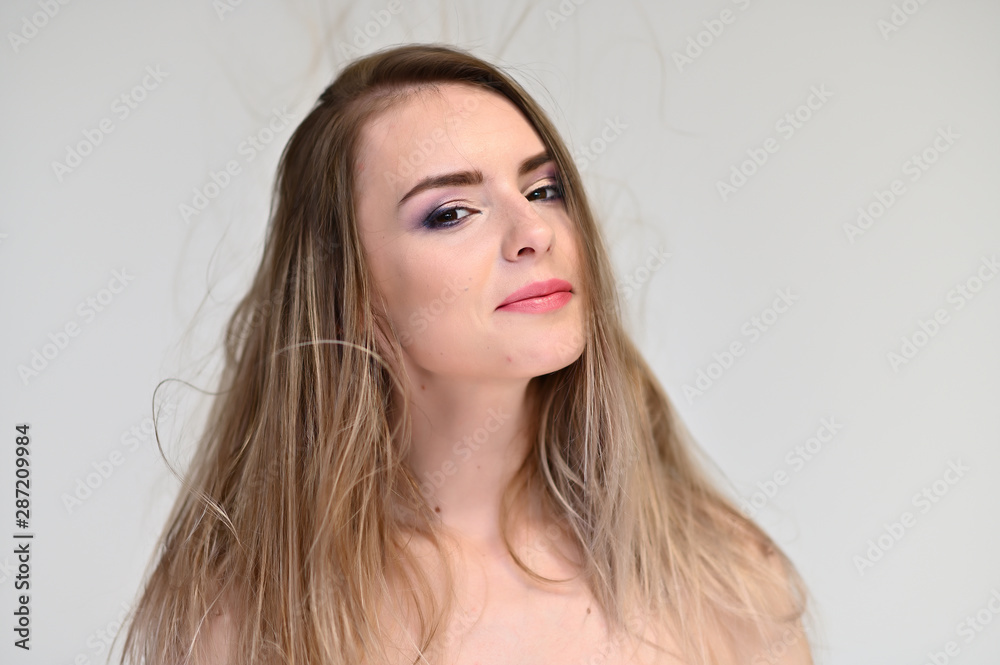 A close-up portrait of a cute girl, a young woman with beautiful curly hair on a white background with excellent face skin and outstanding fashionable make-up. Beauty, brightness. A close-up portrait of a cute girl, a young woman with beautiful curly hair on a white background with excellent face skin and outstanding fashionable make-up. Beauty, brightness.