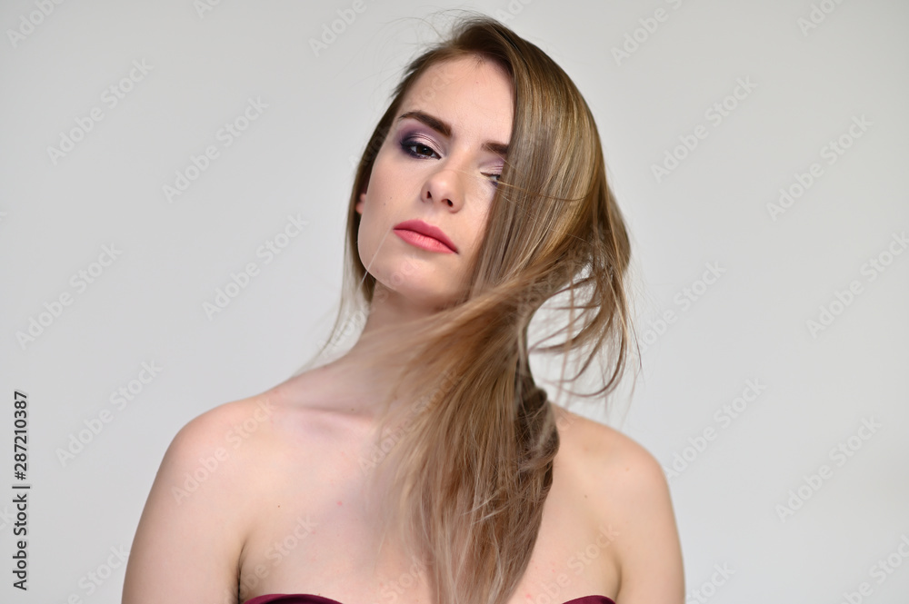 A close-up portrait of a cute girl, a young woman with beautiful curly hair on a white background with excellent face skin and outstanding fashionable make-up. Beauty, brightness. A close-up portrait of a cute girl, a young woman with beautiful curly hair on a white background with excellent face skin and outstanding fashionable make-up. Beauty, brightness.