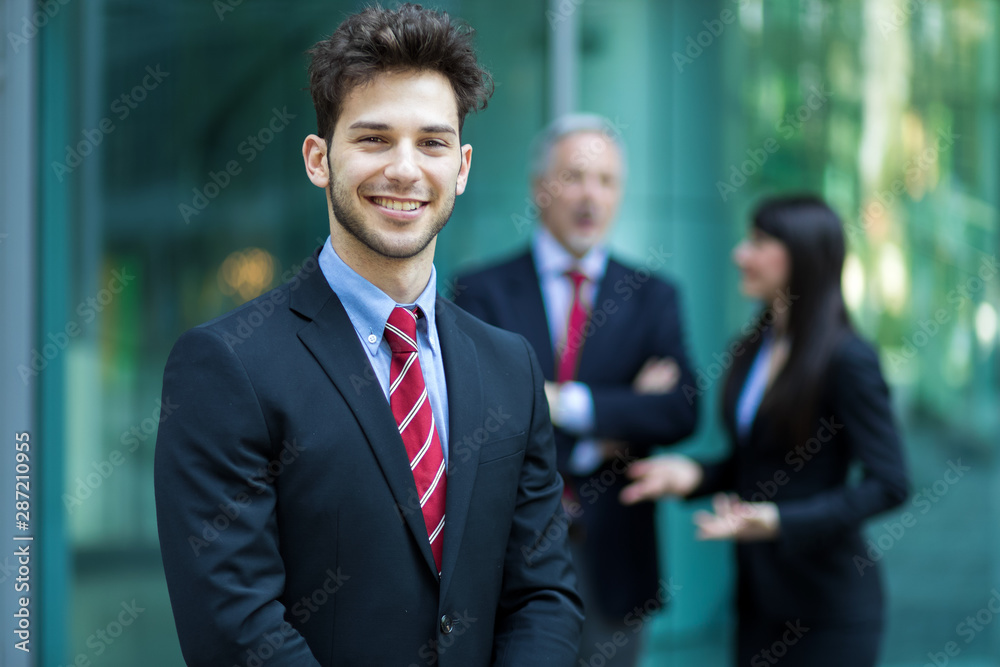 Business team smiling outdoor in a modern urban setting Business team smiling outdoor in a modern urban setting