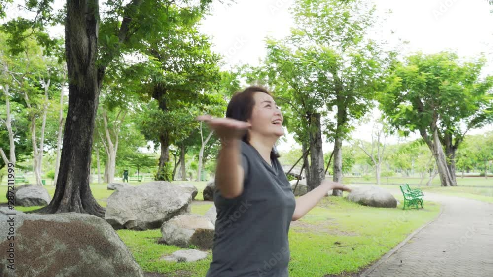 woman in casual dress turning around and smiling on camera in the park. woman in casual dress turning around and smiling on camera in the park.