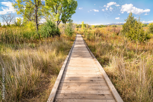 wooden boardwalk across wetland © MarekPhotoDesign.com