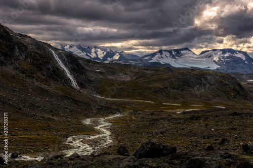 Water Cascade and waterfall in jotunheimen np with Hurrungane mountain range in the background