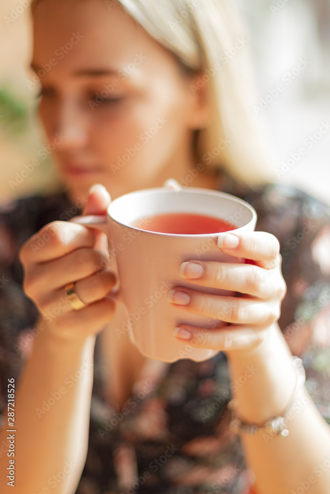 05.08.2019 Kyiv, Ukraine: two pretty women holding mugs of delicious hot tea, drinking and having fun talking 05.08.2019 Kyiv, Ukraine: two pretty women holding mugs of delicious hot tea, drinking and having fun talking