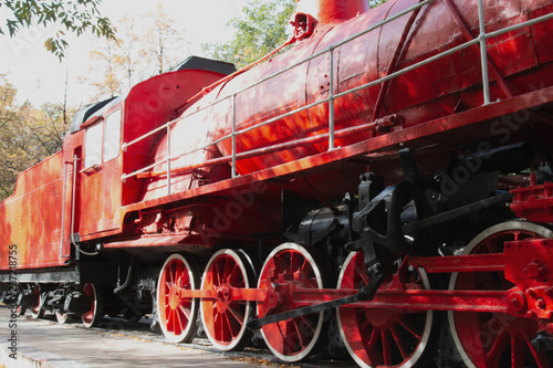 vintage red steam locomotive for rail cars
