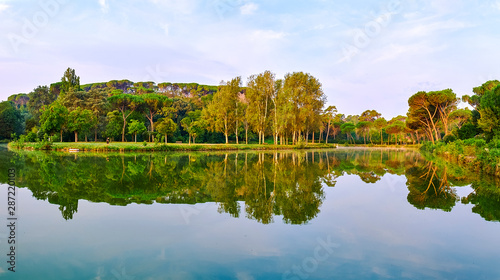 City park in Rome, Italy: Villa Ada at sunrise panorama with a person jogging