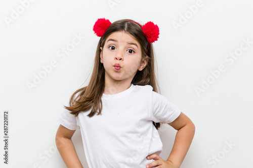 Little caucasian girl with costume and accessories having fun