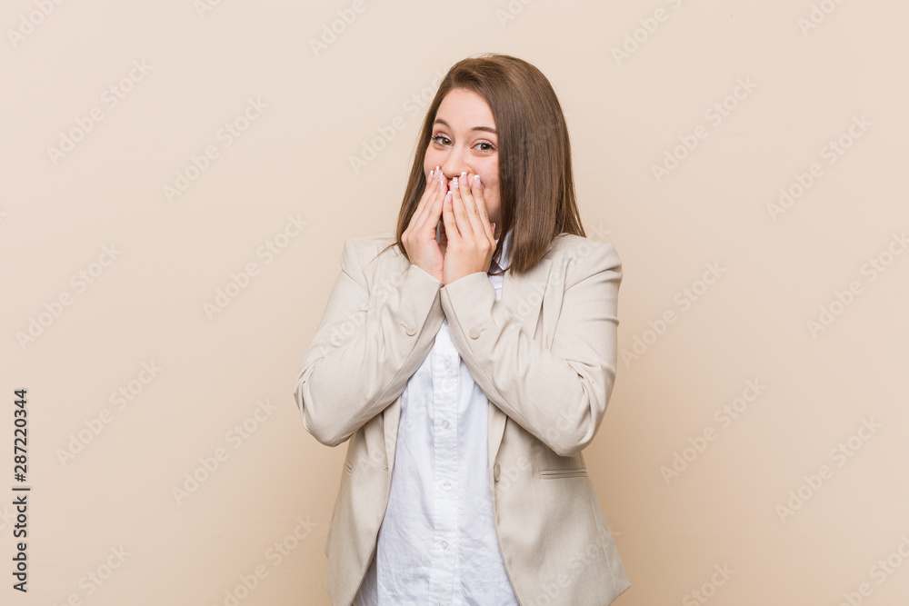 Young business woman laughing about something, covering mouth with hands. Young business woman laughing about something, covering mouth with hands.