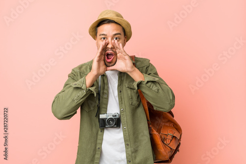 Young filipino traveler man shouting excited to front.