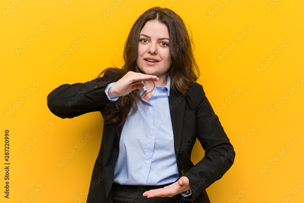 Young plus size caucasian business woman holding something with both hands, product presentation. Young plus size caucasian business woman holding something with both hands, product presentation.